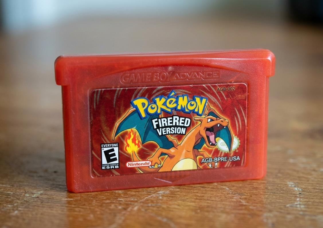 Pokémon FireRed GBA game box art featuring Charizard on a red background